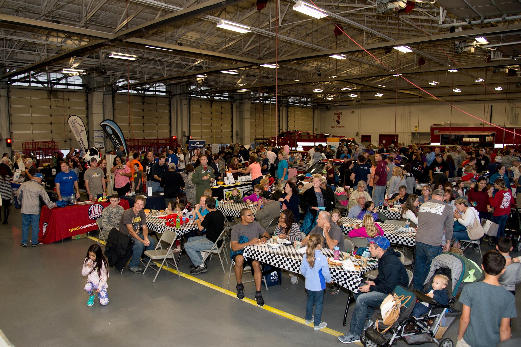Team Dover members gather for the NASCAR Social Sept. 30, 2016, in the 436th Civil Engineer Squadron Fire Department on Dover Air Force Base, Del. More than 20 base and local agencies set up booths and handed out free food and gifts. (U.S. Air Force photo by Mauricio Campino)