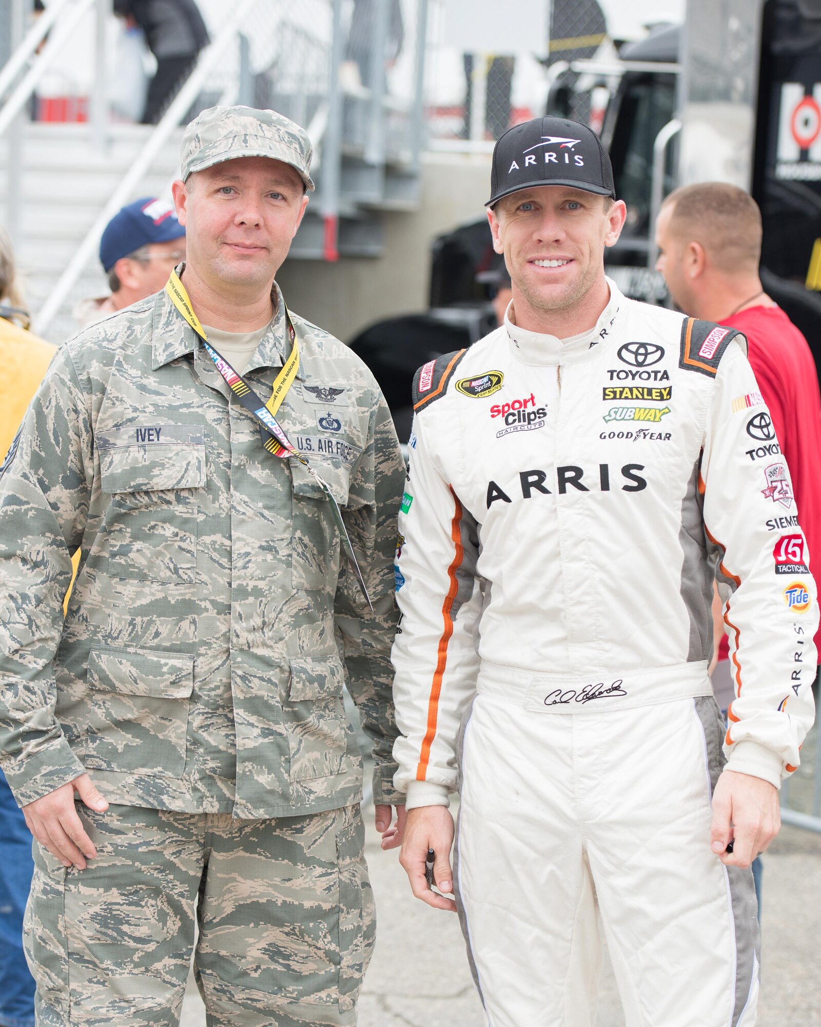 Tech Sgt. Jerry Ivey, 436th Command Post NCO in charge of training, and Carl Edwards, driver of the No. 19 Arris Toyota Camry, pose for a photo Oct. 1, 2016, at Dover International Speedway, Del. Ivey, an avid race fan, participated in the Troops to Tracks program which honors service members, veterans and military families at NASCAR events. (U.S. Air Force photo by Mauricio Campino)