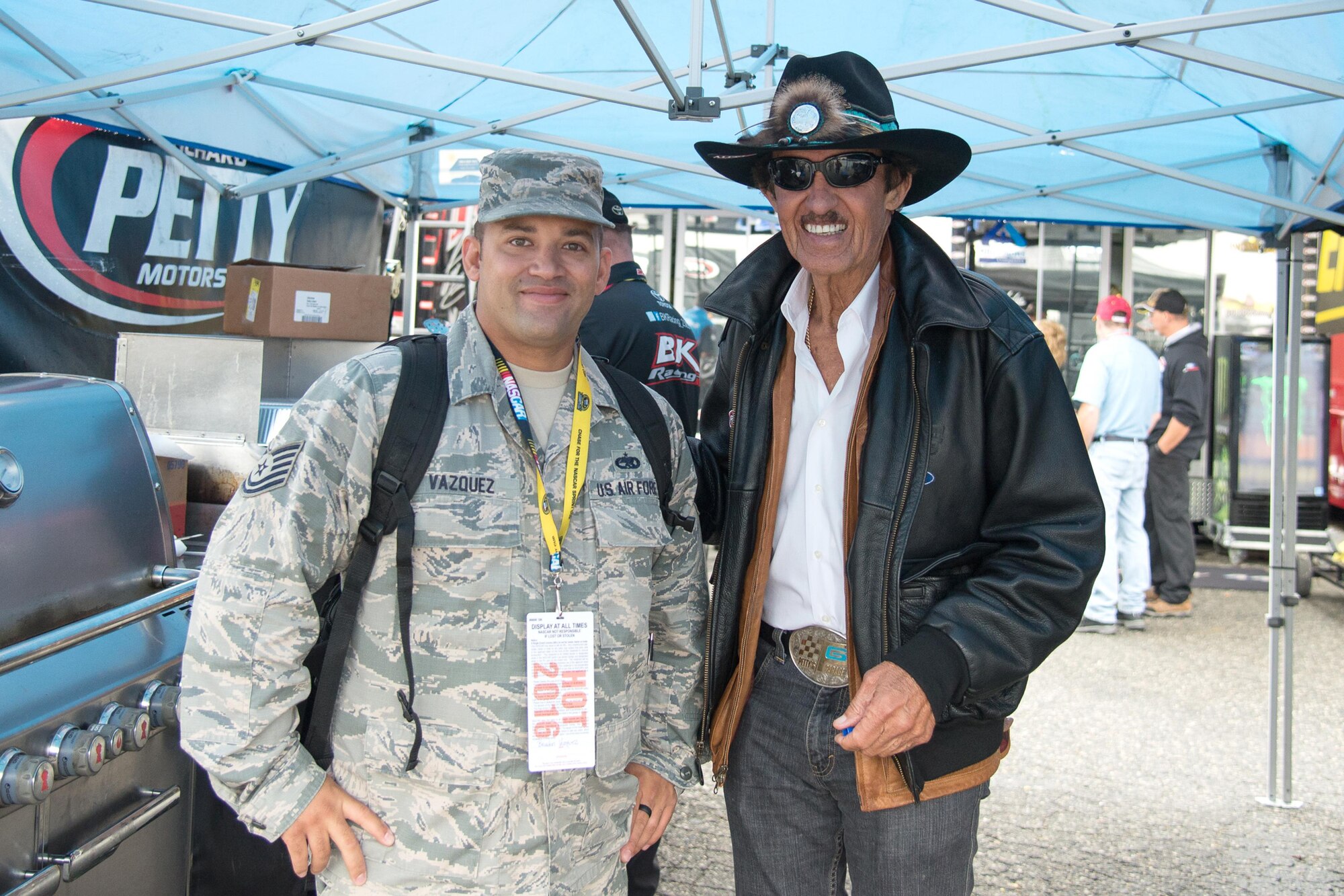Tech Sgt. Brandon Vazquez, 436th Maintenance Operations Squadron, poses for a photo with Richard Petty,  NASCAR legend and owner of the No. 43 Air Force Ford Fusion, Oct. 1, 2016, at Dover International Speedway, Del.  Vazquez attended the race as part of the Troops to Tracks program, which treats service members, veterans and military families to special garage tours, driver meet-and-greets and VIP experiences at NASCAR races. (U.S. Air Force photo by Mauricio Campino)