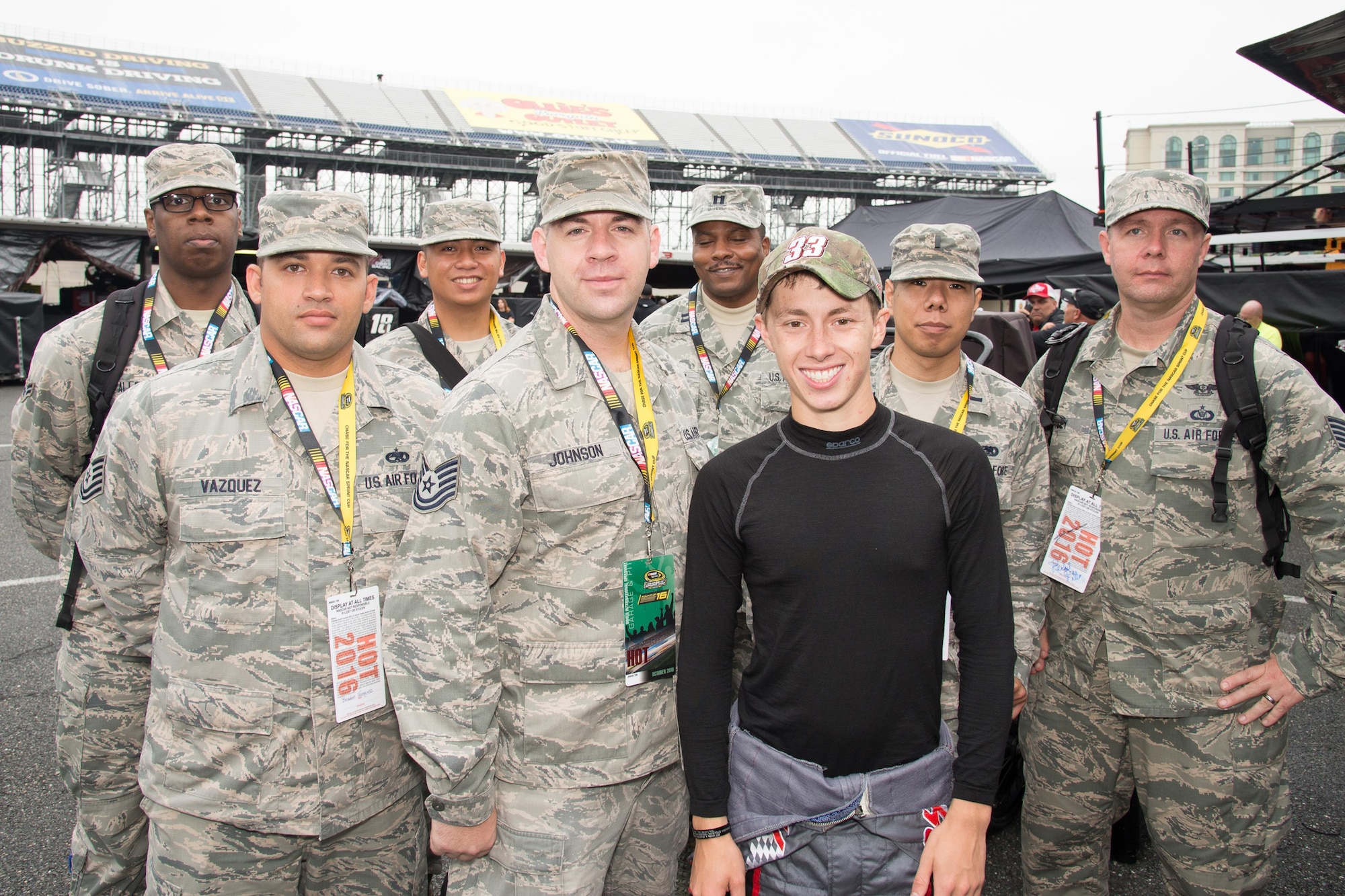 Team Dover Airmen pose with Brandon Jones, driver of the No. 33 Nexteer Chevy Camaro, during a behind-the-scenes tour sponsored by the Troops to Tracks program Oct. 1, 2016, at Dover International Speedway, Del. The program treats service members, veterans and military families to special VIP access at NASCAR races. (U.S. Air Force photo by Mauricio Campino)