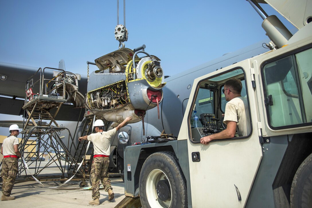 Air Force Senior Airman Zackery Schaadt lifts a new engine as airmen guide it into place on a C-130J Super Hercules aircraft at Bagram Airfield, Afghanistan, Oct. 1, 2016. Schaadt is an engine mechanic assigned to the 455th Expeditionary Aircraft Maintenance Squadron. Air Force photo by Senior Airman Justyn M. Freeman