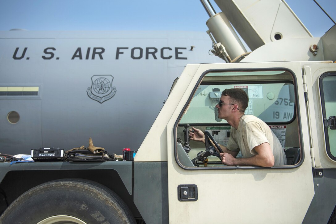 Air Force Senior Airman Zackery Schaadt operates a crane to help install a new C-130J Super Hercules aircraft engine at Bagram Airfield, Afghanistan, Oct. 1, 2016. Schaadt is an engine mechanic assigned to the 455th Expeditionary Aircraft Maintenance Squadron. Air Force photo by Senior Airman Justyn M. Freeman