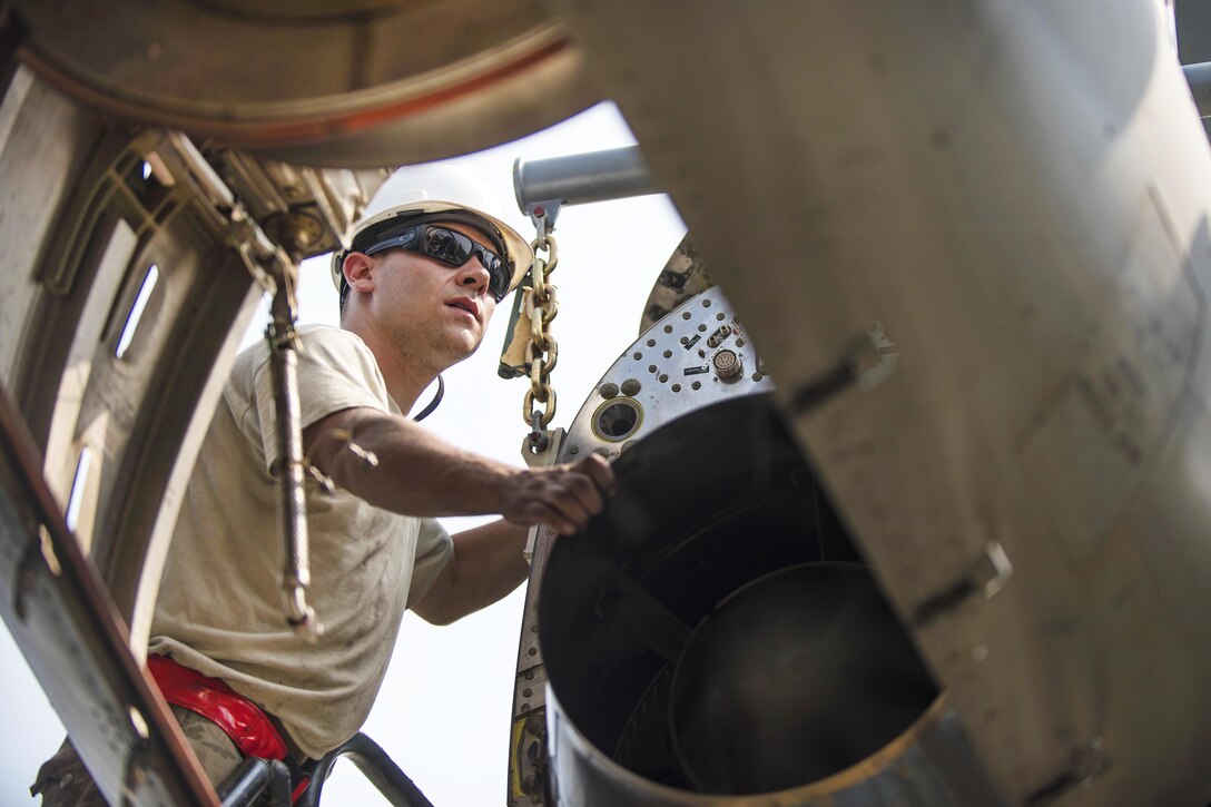 Air Force Senior Airmen Thomas Budd guides a new C-130J Super Hercules aircraft engine into place at Bagram Airfield, Afghanistan, Oct. 01, 2016. Budd is an electrician assigned to the 455th Expeditionary Aircraft Maintenance Squadron. Air Force photo by Senior Airman Justyn M. Freeman