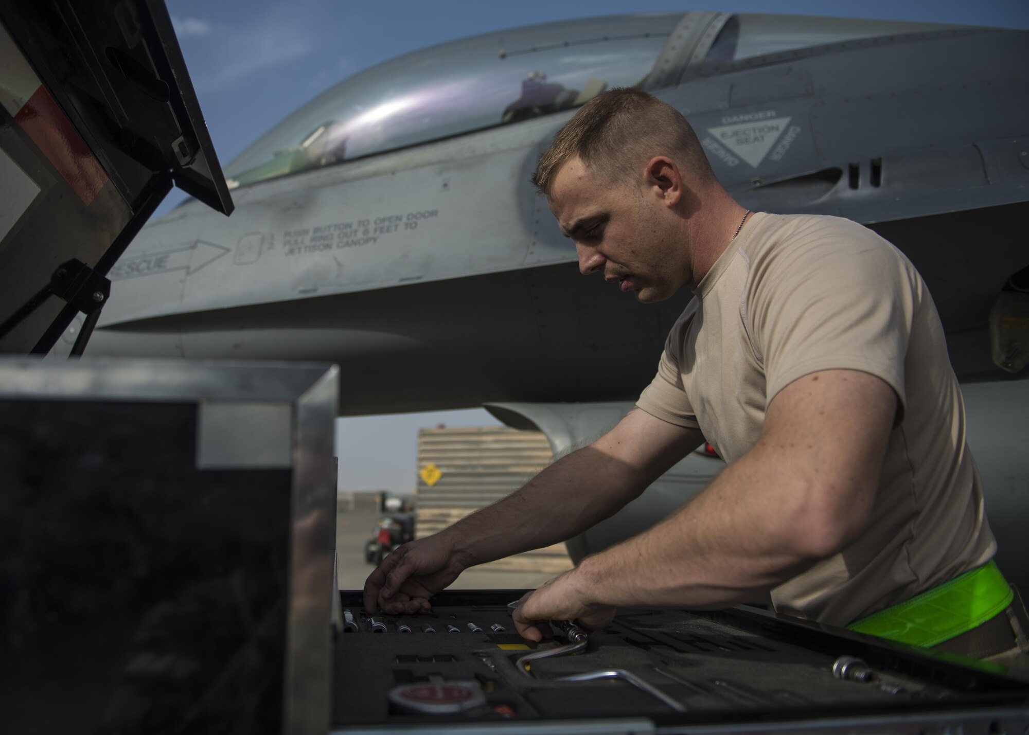 Staff Sgt. Michael Dukes, 455th Expeditionary Aircraft Maintenance Squadron electrical and environmental systems specialist, gathers tools to repair a heat exchanger, Bagram Airfield, Afghanistan, Oct. 5, 2016. Heat exchangers are used to transfer heat between one or more fluids. (U.S. Air Force photo by Senior Airman Justyn M. Freeman)