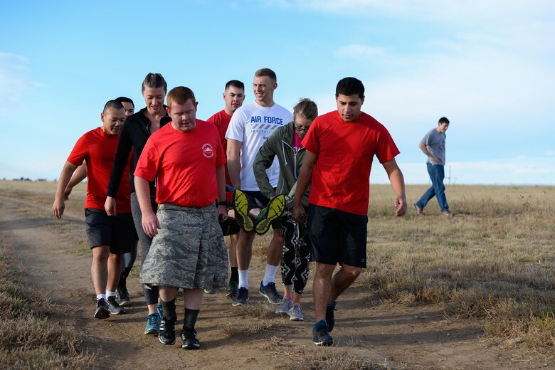Participants carry a litter during Schriever Week’s Warrior Run at Schriever Air Force Base, Colorado, Friday, Sept. 30, 2016. The 1-mile obstacle course include puzzle solving, team carry and weighted obstacle carry. Each team must consist of six members. (U.S. Air Force photo/Christopher DeWitt)