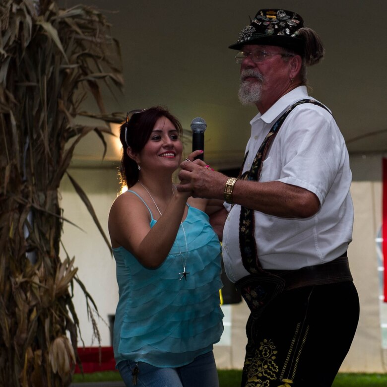 Diana Pajares, an Oktoberfest attendee dances with a member of The Happy Dutchman band during an Oktoberfest celebration at Joint Base Langley-Eustis, Va., Sept. 30, 2016. The Happy Dutchman band  is based in the Tidewater area and have been performing at the Fort Eustis celebration for five years. (U.S. Air Force photo by Airman 1st Class Derek Seifert)