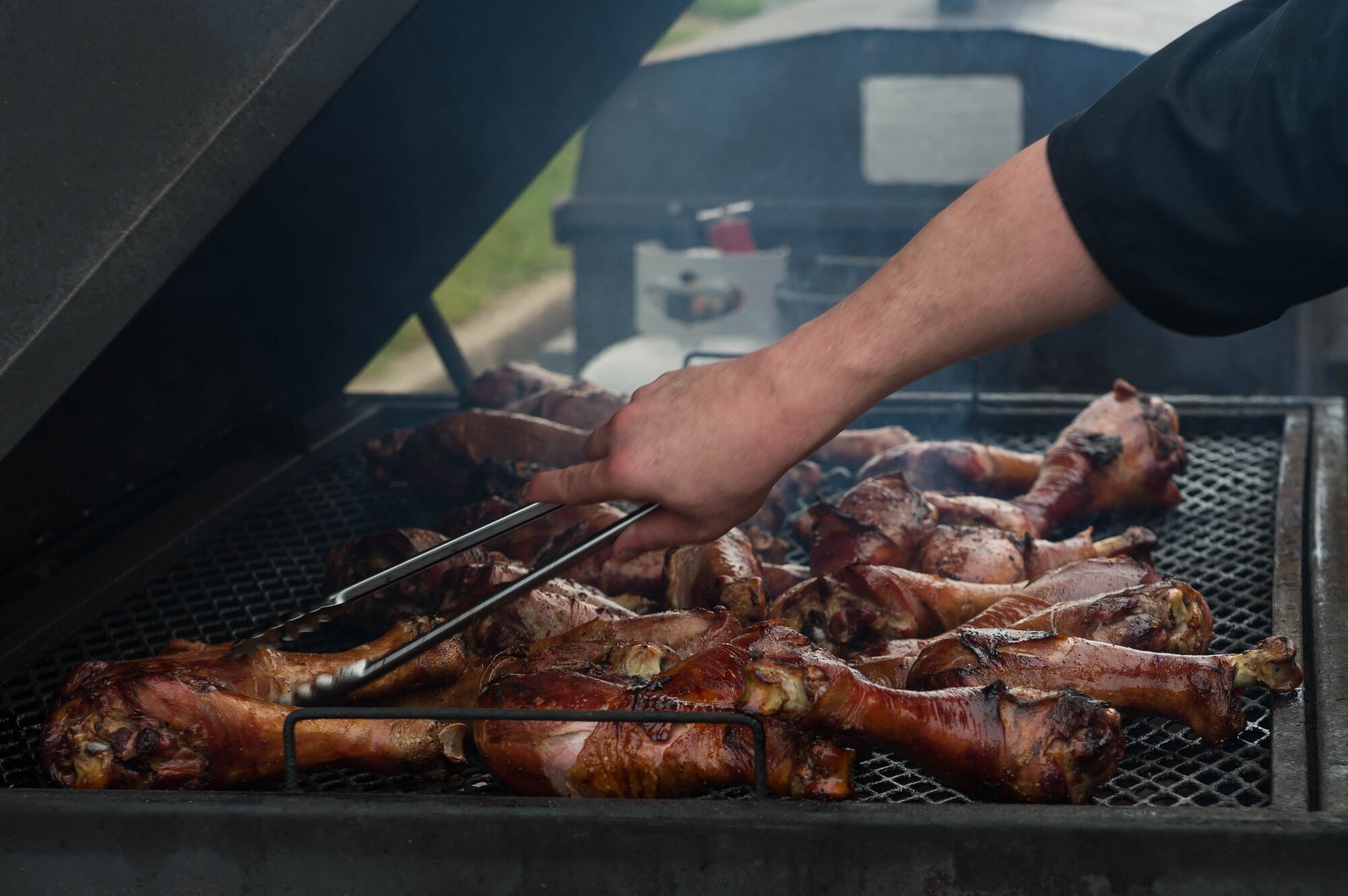 A chef cooks chicken legs at an Oktoberfest celebration at Joint Base Langley-Eustis, Va., Sept. 30, 2016. The event included chicken, bratwurst, beer and music for the event attendees. (U.S. Air Force photo by Airman 1st Class Derek Seifert)