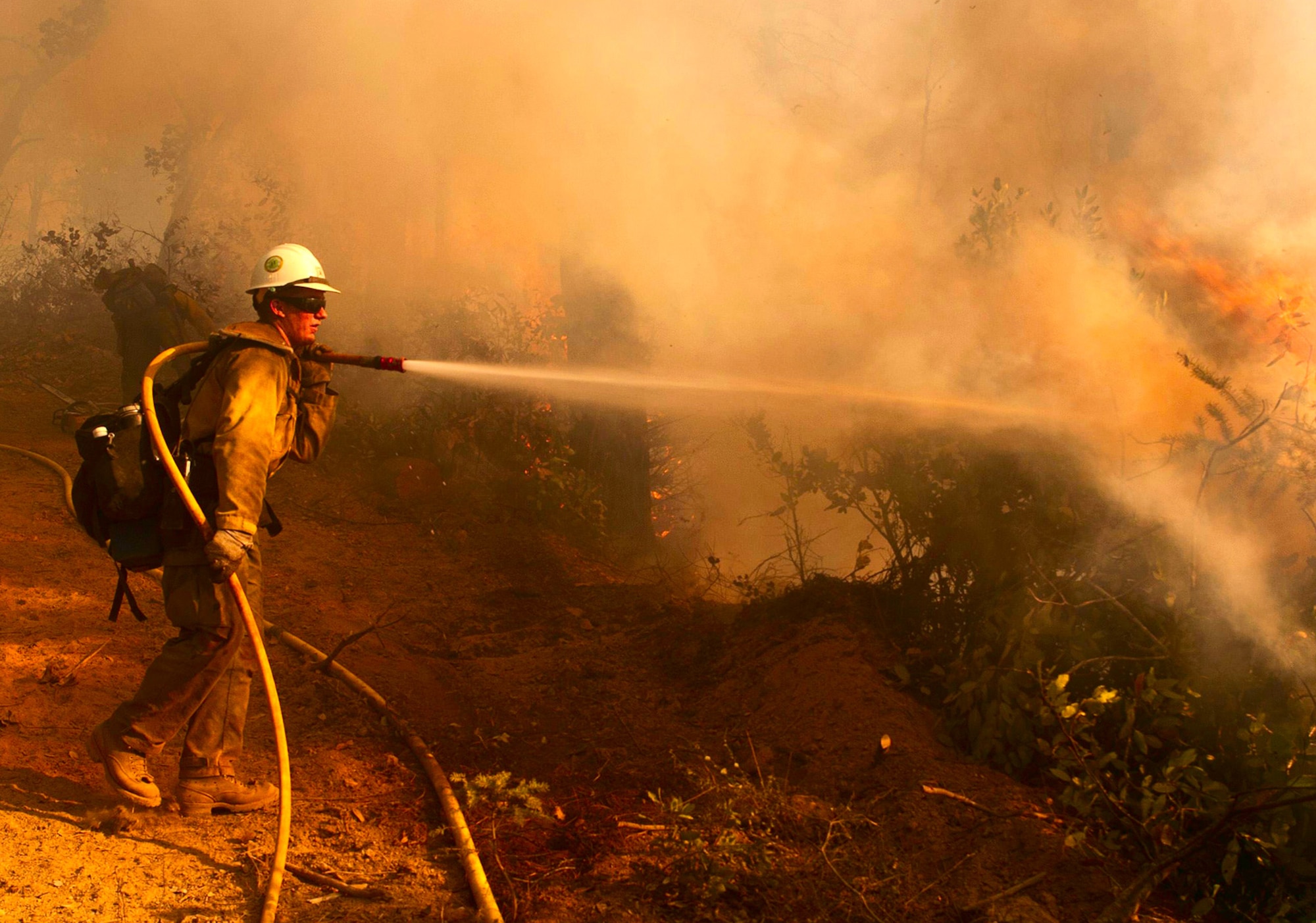 A firefighter suppresses hot spots during the 2014 wildfire season in California. Defense Logistics Agency Troop Support began providing firefighting and other materiel to wildland firefighters with the U.S. Forest Service in 2014. 