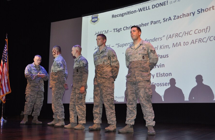 The 932nd Airlift Wing commander, Col. Jonathan Philebaum, presents a special coin of recognition to members of his 932nd Security Forces Squadron at his commander's call meeting in front of the entire wing on Sept. 11, 2016, at Scott Air Force Base, Illinois.  They were all recognized as being "Superstar Defenders" for security work they provided to the Air Force Reserve Command Chaplain's conference.  To the right of the commander are Master Sgt. Daniel Paus, Tech Sgt. Erik Ervin, Senior Airman Colby Crosser, and Staff Sgt. Zachary Elston  (U.S. Air Force photo by Tech. Sgt. Jodi Ames)