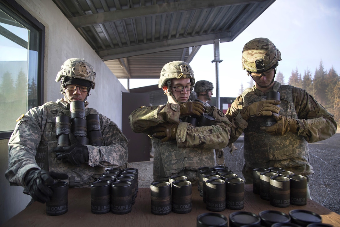 Soldiers gather canisters containing M67 fragmentation grenades before heading out to safety pits during a live-fire training exercise at Kraft Range at Joint Base Elmendorf-Richardson, Alaska, Sept. 29, 2016. Air Force photo by Alejandro Pena