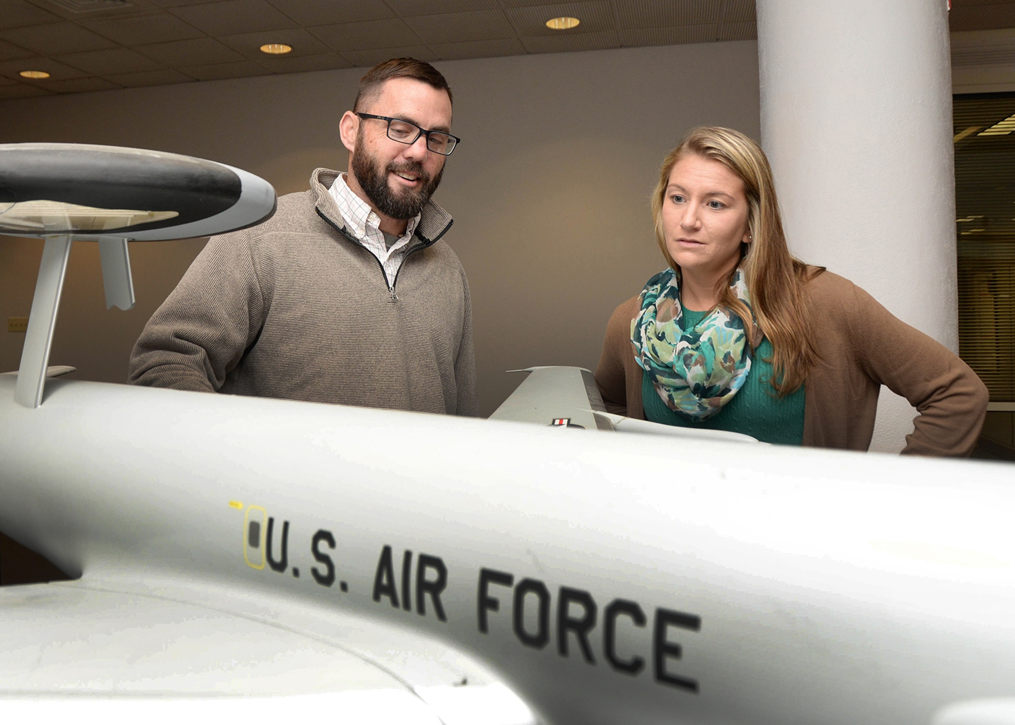 Brian Davies and Ashlee Michaud, National Disability Employment Awareness Month Committee members, look at an Airborne Warning and Control System (AWACS) model on base Oct. 5. Davies, who is disabled, became a member of the Palace Acquire Program, working on the AWACS Diminishing Manufacturing Sources Replacement of Avionics for Global Operations and Navigation (DRAGON) program in Battle Management, following medical problems that were the result of ulcerative colitis. (U.S. Air Force photo by Linda LaBonte Britt)