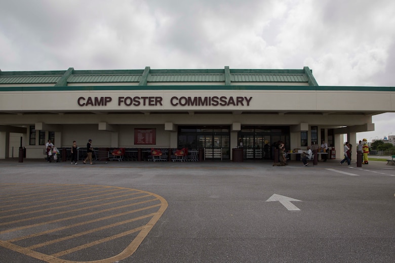 Men and women with the Camp Foster Fire Department hand out free gifts to customers at the commissary on Camp Foster, Okinawa, Sept. 27, 2016. Emergency Awareness Day intends to increase the knowledge of the community by alerting people and providing them with a better understanding of the actions that need to be taken in the case of an emergency. (U.S. Marine Corps photo by MCIPAC Combat Camera Lance Cpl. Christian J. Robertson /Released)   