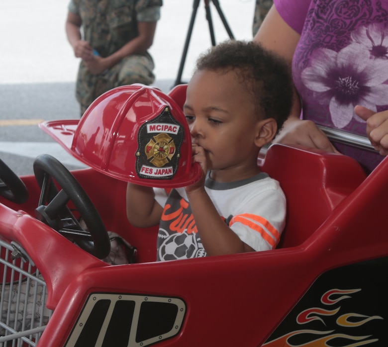A child plays with a plastic fireman’s hat during Emergency Awareness Day at the commissary on Camp Foster, Okinawa, Sept. 27, 2016. Emergency Awareness Day intends to increase the knowledge of the community by alerting people and providing them with a better understanding of the actions that need to be taken in the case of emergency(U.S. Marine Corps photo by MCIPAC Combat Camera PFC. Damion Hatch JR/Released)