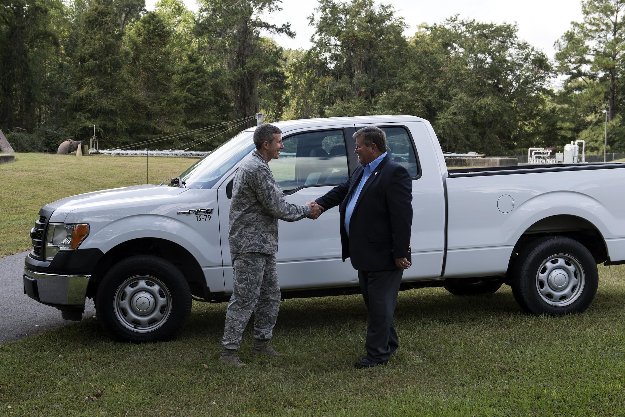 U.S. Air Force Col. Thomas Kunkel, 23d Wing commander, shakes hands with Bill Slaughter, Lowndes County Commission chairman, during a ceremony, Oct. 3, 2016, in Valdosta, Ga. Kunkel and Slaughter are members of the Moody Community Partnership Committee, which creates mutually beneficial partnerships between the base, local and city governments to improve cost efficiencies. (U.S. Air Force photo by  Airman 1st Class Janiqua P. Robinson)