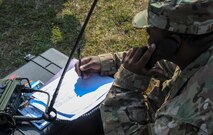 U.S. Air Force Tech. Sgt. Adrian Jackson, 7th Weather Squadron, Detachment 2 NCO in charge of airfield operations, writes down notes from a radio transmission during exercise Cadre Focus 16.2 in Grafenwoehr, Germany, Sept. 27, 2016. Cadre Focus is a biannual training event, in which Airmen from the 7th WS and 7th Expeditionary Weather Squadron re-familiarize themselves with skills necessary to integrate with U.S. Army units. Cadre Focus 16.2 is the first time the weather forecasters invited NATO partners to train on these skills alongside them. (U.S. Air Force photo by Staff Sgt. Timothy Moore)