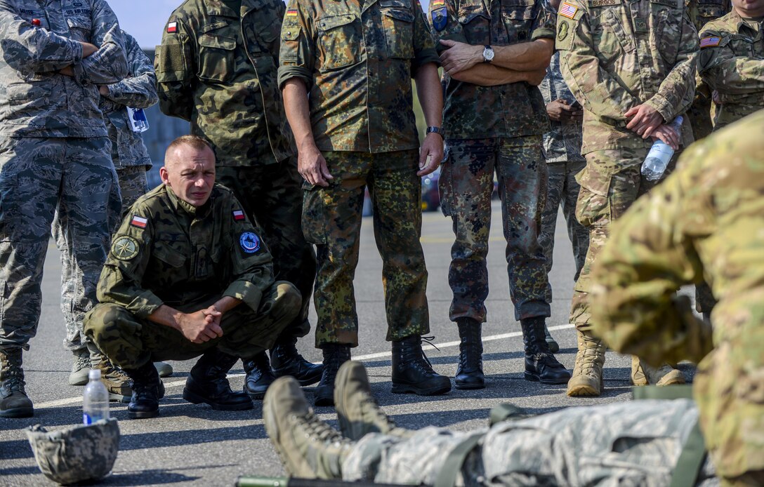 Polish armed forces Warrant Officer Andrzej Kozlowski, a weather forecaster, watches as U.S. Air Force Airmen practice loading a patient onto a U.S. Army UH-60 Black Hawk during exercise Cadre Focus 16.2 in Grafenwoehr, Germany, Sept. 27, 2016. Cadre Focus is a biannual training event, in which Airmen from the 7th Weather Squadron and 7th Expeditionary Weather Squadron re-familiarize themselves with skills necessary to integrate with U.S. Army units. Cadre Focus 16.2 is the first time the weather forecasters invited NATO partners to train on these skills alongside them. (U.S. Air Force photo by Staff Sgt. Timothy Moore)