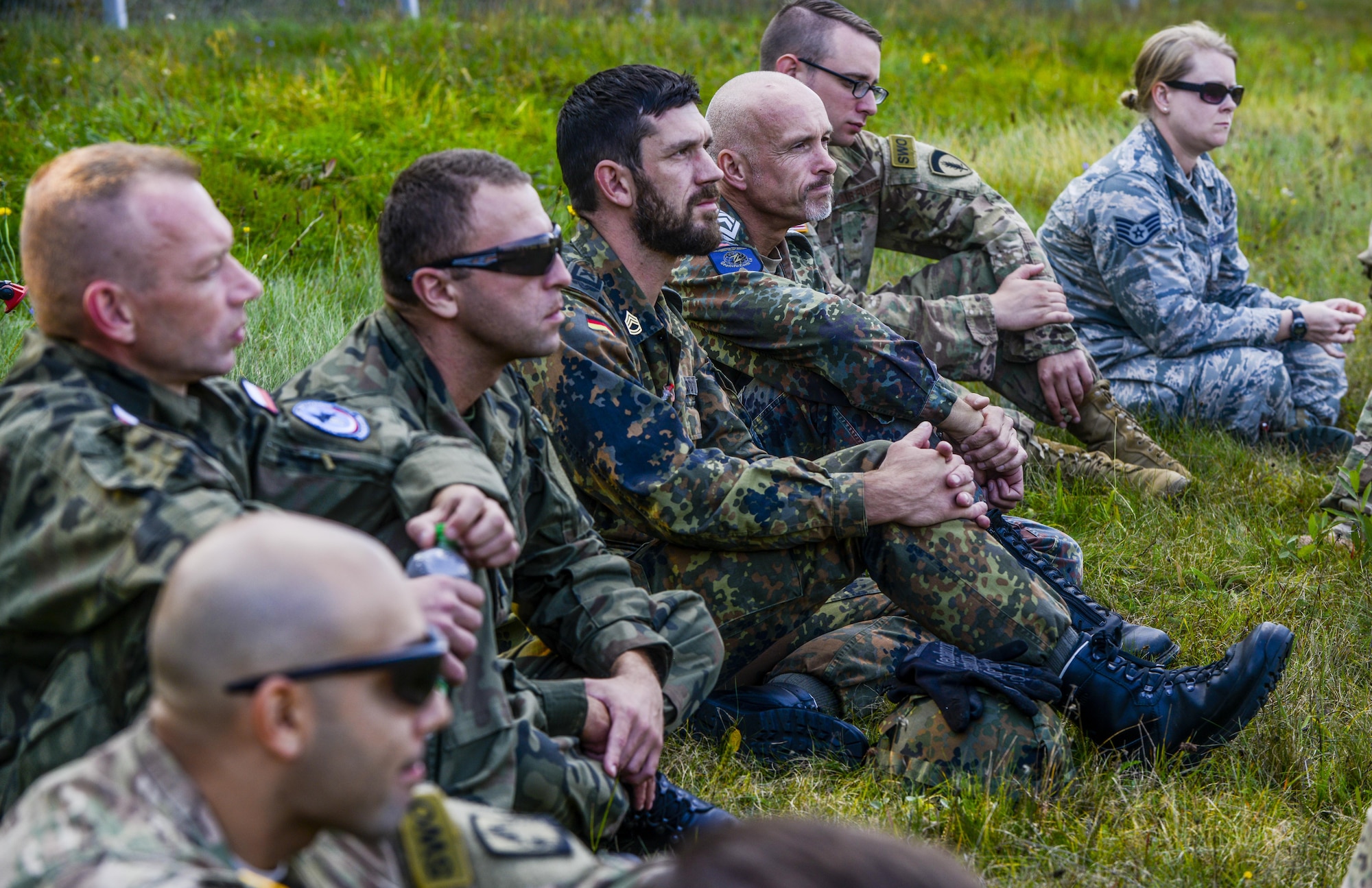 U.S., Polish and German service members wait to discuss the good and bad of the day’s training in Grafenwoehr, Germany, Sept. 27, 2016. Service members from three NATO partners came together to train on basic U.S. Army skills during exercise Cadre Focus 16.2. Cadre Focus is a biannual training event for Airmen from the 7th Weather Squadron and 7th Expeditionary Weather Squadron. Cadre Focus 16.2 marked the first time the weather Airmen invited their NATO partners to the training event. (U.S. Air Force photo by Staff Sgt. Timothy Moore)