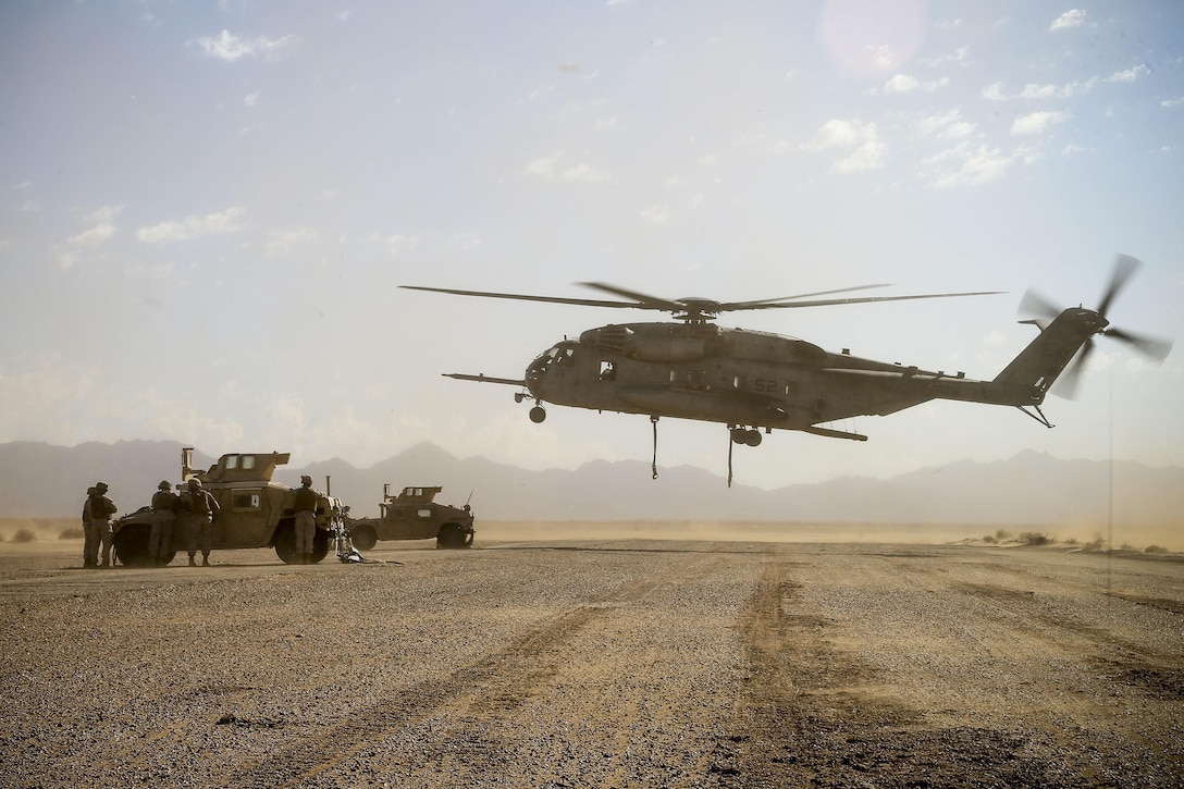 A Marine Corps CH-53E Super Stallion helicopter prepares to lift Humvees during a slingload tactics exercise at Auxiliary Airfield II, Yuma, Ariz., Sept. 30, 2016. The helicopter crew is assigned to Marine Aviation Weapons and Tactics Squadron One. The training is part of Weapons and Tactics Instructor 1-17, a seven-week training event providing standardized tactical training and certification of unit instructor qualifications to support Marine aviation training and readiness. Marine Corps photo by Staff Sgt. Artur Shvartsberg 