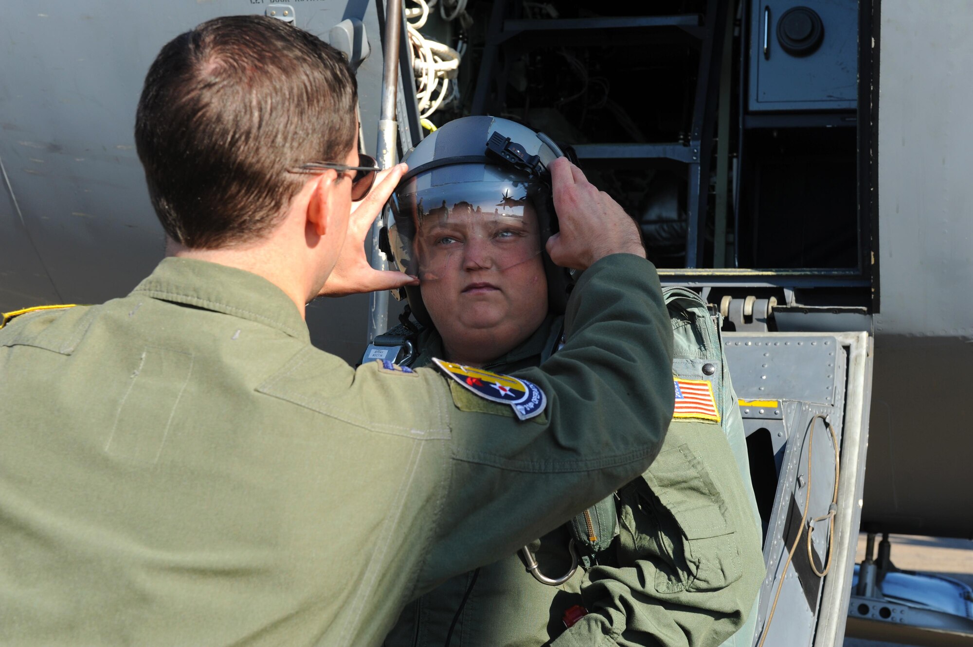 (From left) U.S. Air Force U.S. Air Force Capt. Seth Lake, 314th Operations Group evaluator, adjusts an aircrew helmet for James Rogers, 17, as he dons a flight suit and aircrew accoutrements before stepping to the flightline for his Oct. 3, 2016, tour of Little Rock Air Force Base, Ark. Rogers received the tour as part of the Pilot for a Day program, which provides children who have serious or chronic illnesses an opportunity to be part of a flying squadron for an entire day. 