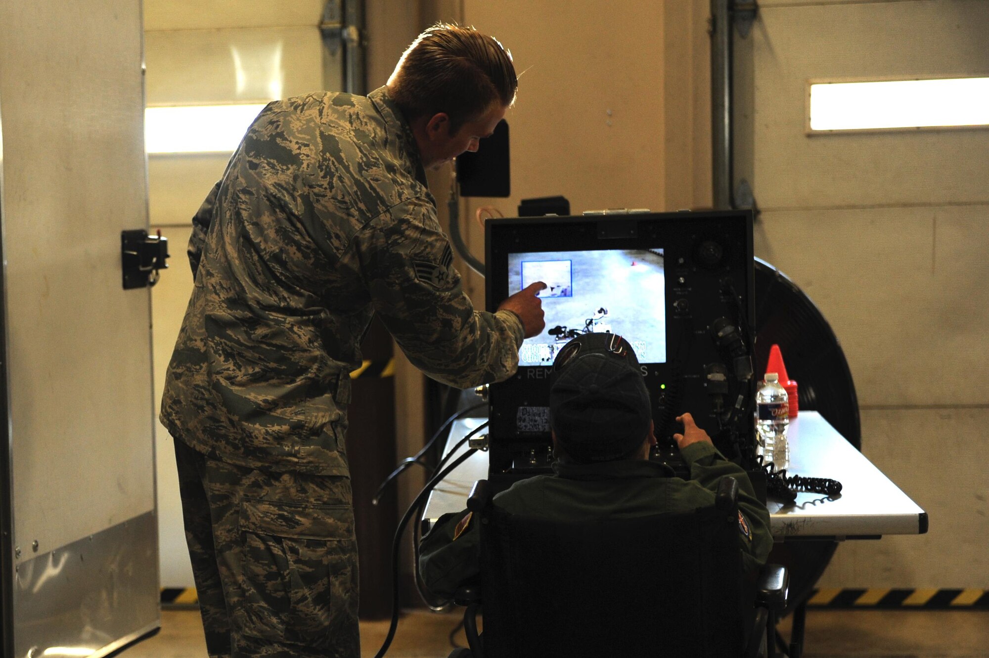 (From left) U.S. Air Force Senior Airman Htyler Kelly, 19th Civil Engineer Squadron Explosive Ordinance Disposal technician, explains how an EOD robot works to James Rogers, 17, during his Pilot for a Day visit Oct. 3, 2016, to Little Rock Air Force Base, Ark. Rogers received the tour as part of the Pilot for a Day program, which provides children who have serious or chronic illnesses an opportunity to be part of a flying squadron for an entire day. 