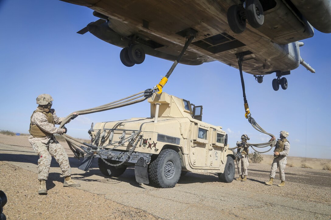 Marines prepare a Humvee to be lifted by a CH-53E Super Stallion helicopter during a slingload tactics exercise at Auxiliary Airfield II, Yuma, Ariz., Sept. 30, 2016. The Marines are assigned to 1st Transport Support Battalion, 1st Marine Logistics Group. Marine Corps photo by Staff Sgt. Artur Shvartsberg