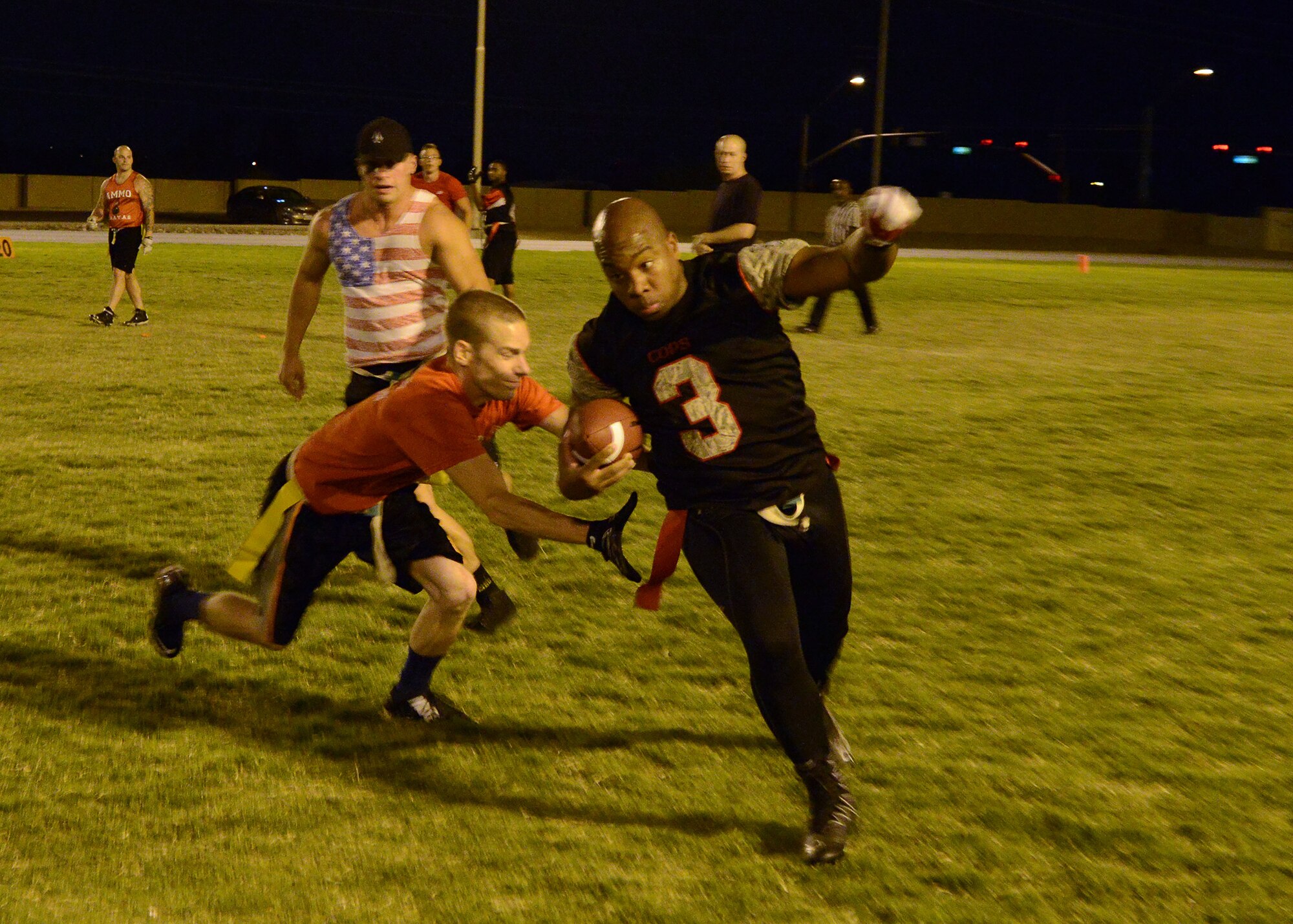 David Hicks, 56th Security Forces Squadron quarterback, avoids a defender during an intramural flag football game against 56th Equipment Maintenance Squadron/AMMO Sept. 16, 2016 at Luke Air Force Base, Ariz. (U.S. Air Force photo by Senior Airman Devante Williams)