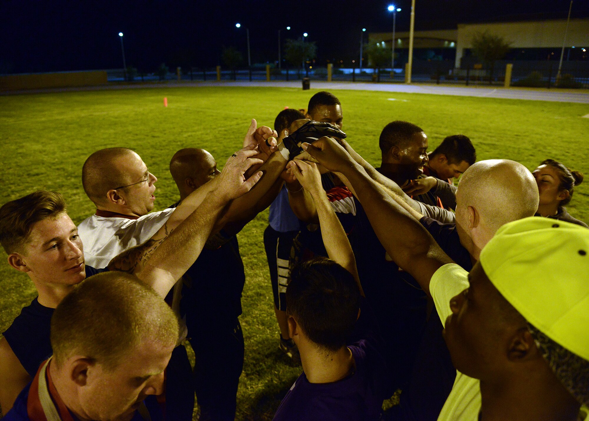 Members of the 56th Security Forces Squadron football team performs their chant during an intramural flag football game against 56th Equipment Maintenance Squadron/AMMOSept. 16, 2016 at Luke Air Force Base, Ariz. SFS defeated EMS/AMMO 7-6. (U.S. Air Force photo by Senior Airman Devante Williams)