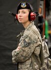 Staff Sgt. Megan VanValkenburg, 166th Security Forces Squadron, New Castle Air National Guard Base, Del., watches race cars take warm-up laps for the NASCAR Xfinity Series Drive Sober 200 Oct. 2, 2016, at the Dover International Speedway, Dover, Del. VanValkenburg and other members of the military were part of the pre-race ceremonies and honorary pit crew members. (U.S. Air Force photo by Roland Balik)