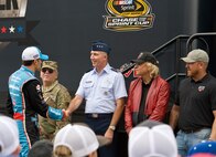 Aric Almirola, NASCAR Sprint Cup Series driver for the No. 43 Smithfield Ford, shakes hands with Lt. Gen. Bill Bender, Chief Information Dominance and Chief Information Officer, Office of the Secretary of the Air Force, the Pentagon, Washington, D.C., during driver introductions for the Citizen Soldier 400 NASCAR Sprint Cup Series race Oct. 2, 2016, at Dover International Speedway, Dover, Del. Almirola was also greeted by Maj. Gen. Frank Vavala, Delaware National Guard adjutant general; Grammy Award-winning musician Joe Walsh, race grand marshal; and retired Oklahoma Army National Guard Staff Sgt. Colt Floyd. (U.S. Air Force photo by Roland Balik)