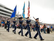 Members of the Dover Air Force Base Honor Guard march across the race track prior to the singing of the national anthem by American Country music singer Easton Corbin Oct. 2, 2016, at Dover International Speedway, Dover, Del. The honor guard presented the colors prior to the Citizen Soldier 400 NASCAR Sprint Cup Series race as two F-16 aircraft from the Texas Air National Guard, 149th Fighter Wing, Joint Base San Antonio-Lackland, Texas, flew overhead. (U.S. Air Force photo by Roland Balik)