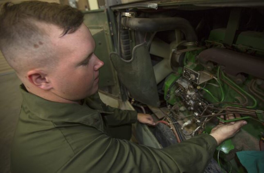 Lance Cpl. Gus O’Brien, an engineer equipment electrical systems technician, Combat Logistics Company 11, Combat Logistics Regiment 15, disassembles a generator while taking out a broken fuel injector aboard Marine Corps Air Station Miramar, Calif., July 22. Microgrids allow generators like these to ensure higher power quality and smooth the output of renewable energy sources, which provides backup power for the entire system, all while lowering costs. (U.S. Marine Corps photo by Cpl. Christopher Johns)