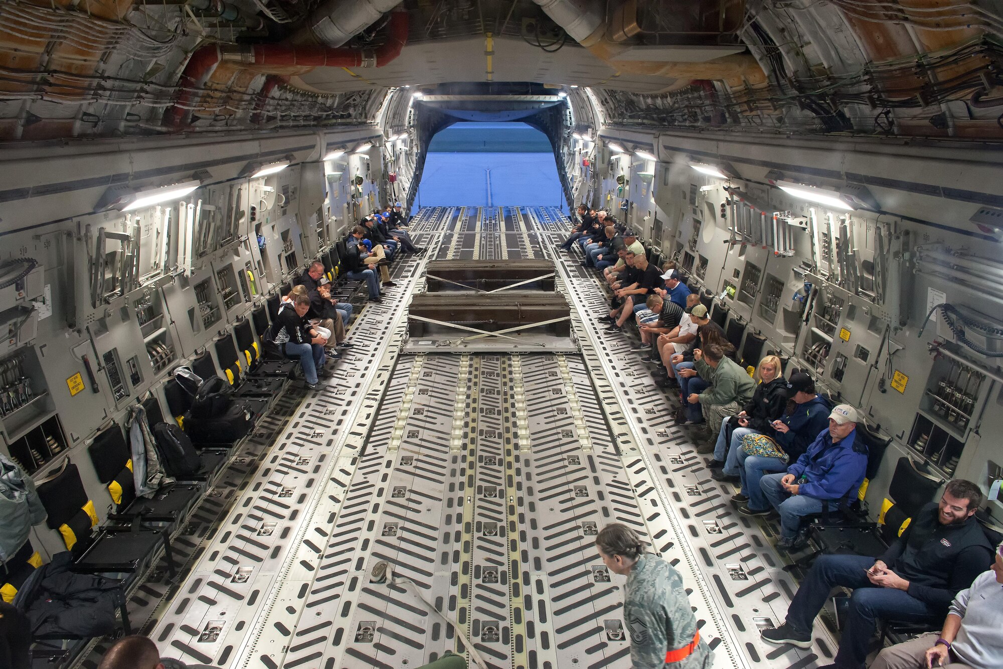 NASCAR orientation flight participants get ready to depart on a C-17A Globemaster III Sept. 29, 2016, on Dover Air Force Base, Del. Upon returning to Dover AFB, participants got to see a combat offload of two pallets with simulated cargo. (U.S. Air Force photo by Roland Balik)