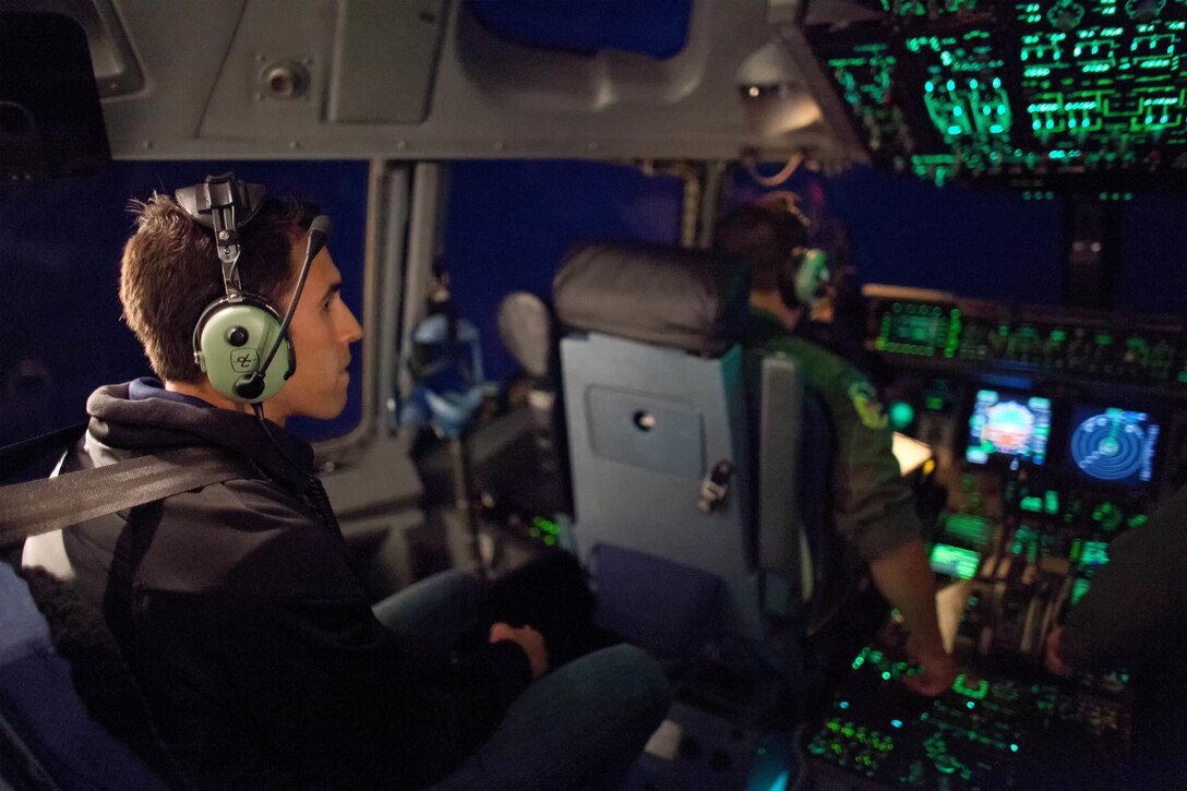 Aric Almirola, NASCAR Sprint Cup Series driver for the No. 43 Smithfield Ford, watches 3d Airlift Squadron pilots fly a C-17A Globemaster III into position for air refueling Sept. 29, 2016, out of Dover Air Force Base, Del. Almirola observed the Globemaster III being refueled by a KC-135R Stratotanker from the 459th Air Refueling Wing, Joint Base Andrews, Md. (U.S. Air Force photo by Roland Balik)