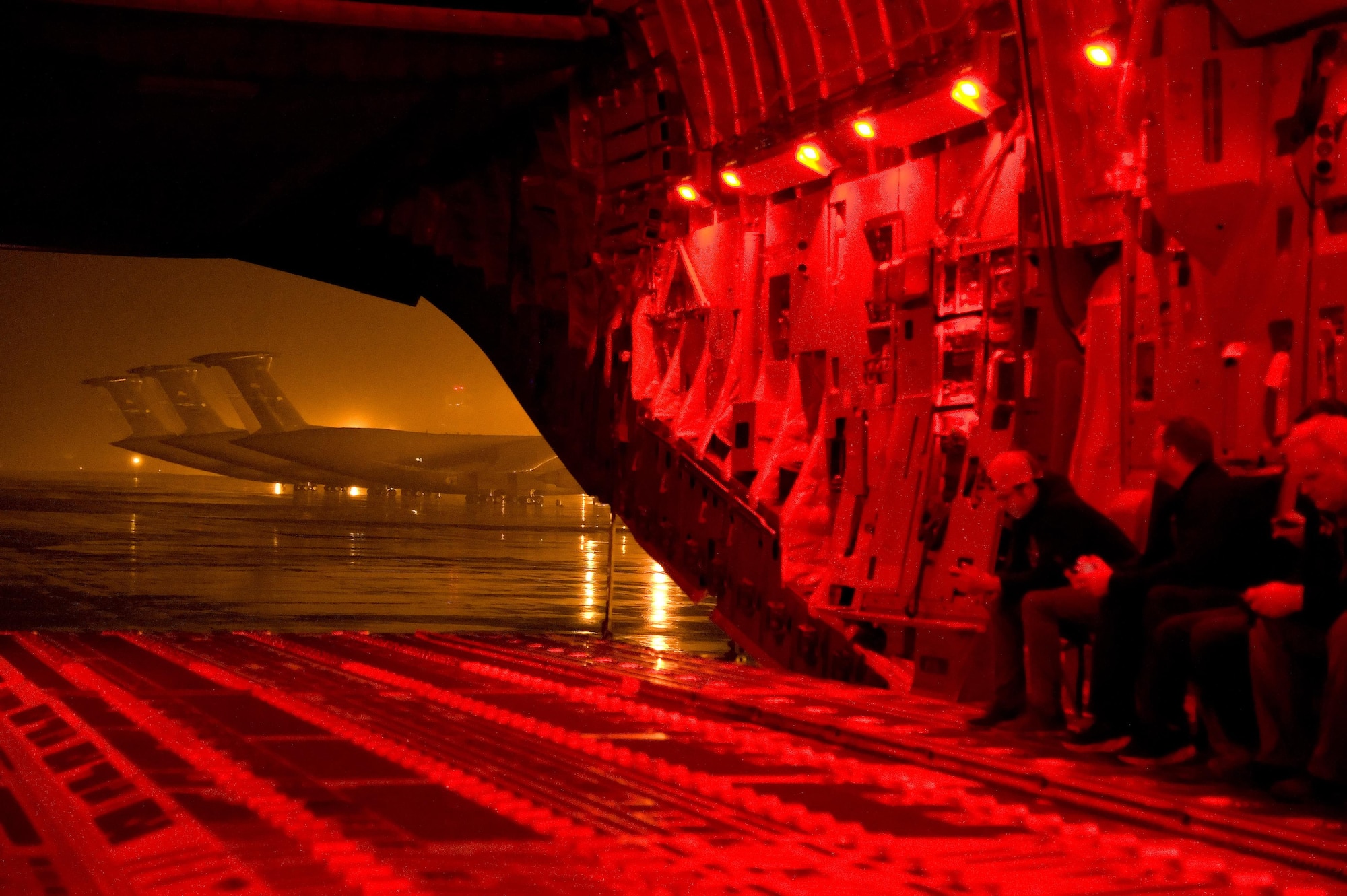 After completing a combat offload demonstration in low-light operations, the C-17A Globemaster III taxis to its parking spot with the rear cargo doors open and red cargo compartment lights glowing Sept. 29, 2016, on Dover Air Force Base, Del. More than 40 NASCAR orientation flight participants including Aric Almirola, NASCAR Sprint Cup Series driver for the No. 43 Smithfield Ford, observed air refueling operation with a KC-135R Stratotanker from the 459th Air Refueling Wing, Joint Base Andrews, Md. (U.S. Air Force photo by Roland Balik)