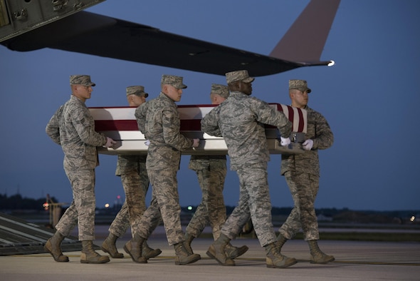 An Air Force carry team carries the remains of Maj. Troy Gilbert Oct. 3, 2016, at Dover Air Force Base, Del. Gilbert was killed Nov. 27, 2006, when his F-16C Fighting Falcon crashed 20 miles northwest of Baghdad. U.S. forces were able to return the F-16 pilot’s remains approximately 10 years after he was killed in combat operations saving the lives of U.S. service members and coalition allies. (U.S. Air Force Photo by Senior Airman Aaron J. Jenne)