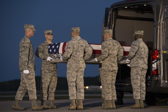 An Air Force carry team places a transfer case carrying Maj. Troy Gilbert’s remains into a vehicle Oct. 3, 2016, at Dover Air Force Base, Del., for transport to the port mortuary and identification center, a part of the Armed Forces Medical Examiner System. Gilbert died Nov. 27, 2006, when his F-16C Fighting Falcon crashed while he was providing close-air support to special operations forces about 30 miles southwest of Balad Air Base, Iraq. His remains were finally returned to the U.S. on Oct. 3, 2016. (U.S. Air Force photo/Senior Airman Aaron J. Jenne)