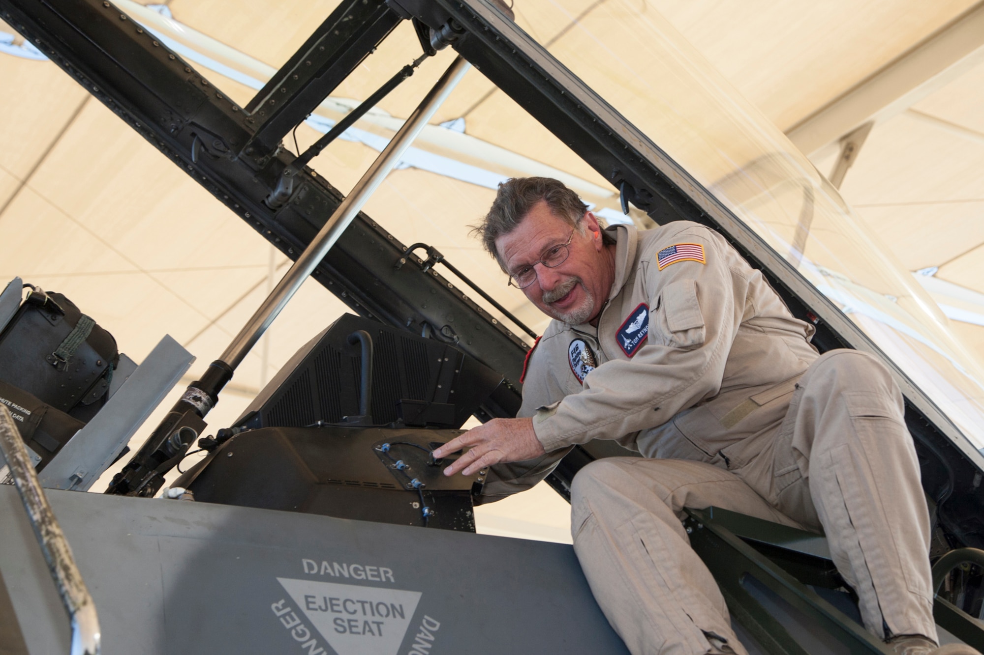 Tom Reynolds, Lockheed Martin aerial photographer, leaves the cockpit for the last time as he completes his final ejection seat flight Sept. 29 after 28 years of immortalizing pilots and aircraft through photos and video. He has been an aerial photographer since 1988 where he supported the continued development of the F-16 Fighting Falcon at the F-16 Combined Test Force. From there his career grew into documenting other airframes – the F-22 Raptor and now the F-35 Lighting II. Reynolds has 1,800 flight hours in the F-16 and a “couple of hundred” more in the F-15 Eagle. The majority have been as photo chase for testing at Edwards. Before working for Lockheed Martin, he worked for General Dynamics – then the manufacturer of the F-16 – in his hometown of Fort Worth, Texas. He came to Edwards as part of a team tasked to perform initial flight tests of two new delta-winged versions of the F-16 called the F-16XL. Reynolds will continue to work for Lockheed Martin on the ground. (Courtesy photo by Chad Bellay/Lockheed Martin)