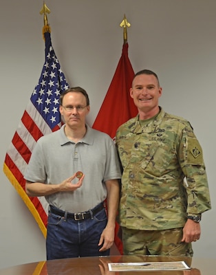 ALBUQUERQUE, N.M. – District Commander Lt. Col. James Booth recognized geographer Doug Walther for his GIS support to local fire and emergency management services, Oct. 3, 2016. The local fire/EMS community sought out assistance in creating a map book of the local Bosque area with all known hazards, routes, and fire hydrants identified. For half the cost of a commercial contract, Walther and the District supported the local services in order to allow them to effectively fight fires in the Bosque areas.