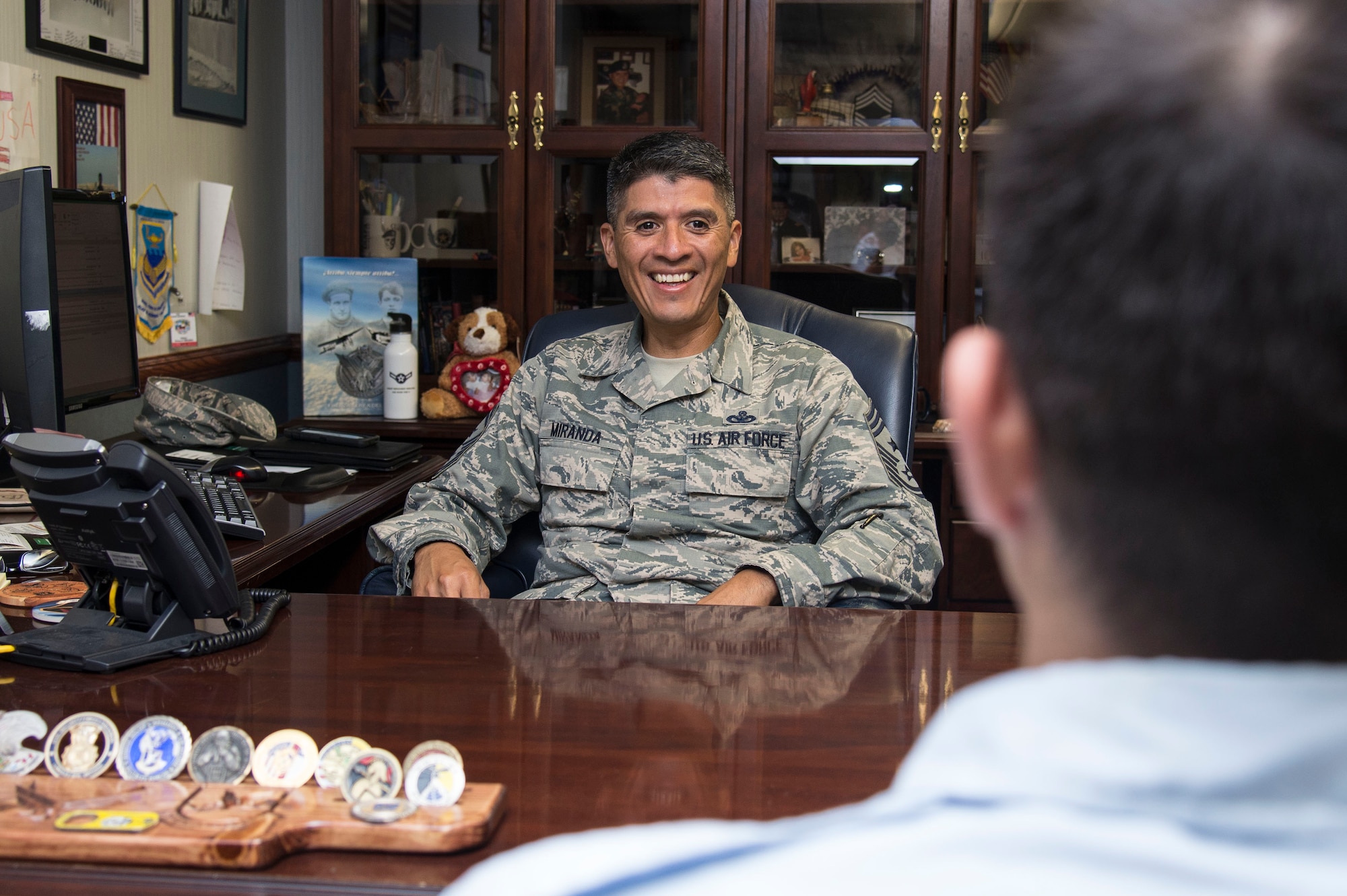 Command Chief Benjamin Miranda Jr., 635th Supply Chain Operations Wing, takes a moment to mentor an Airman. Photo by Airman 1st Class Melissa Estevez
