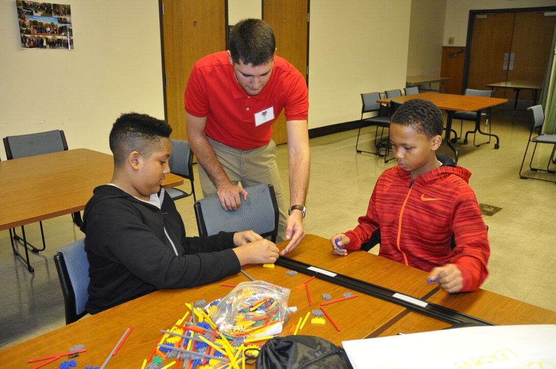 Alec Higgins, U.S. Army Corps of Engineers, Detroit District engineer, instructs students on bridge building techniques at the West Point Society of Michigan Leadership, Ethics and Diversity in STEM conference at Marygrove College. (U.S. Army Corps of Engineers Photo)