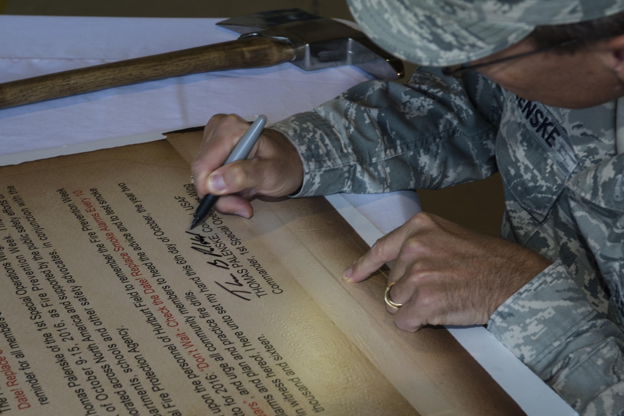Col. Tom Palenske, commander of the 1st Special Operations Wing, signs the Fire Prevention Week Proclamation at Hurlburt Field, Fla., Oct. 5, 2016. Fire Prevention week was established in 1922 by President Woodrow Wilson and is the longest running public health and safety observance on record. (U.S. Air Force photo by Airman 1st Class Joseph Pick)