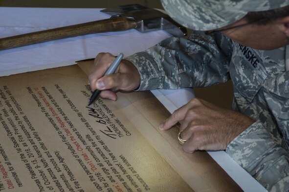 Col. Tom Palenske, commander of the 1st Special Operations Wing, signs the Fire Prevention Week Proclamation at Hurlburt Field, Fla., Oct. 5, 2016. Fire Prevention week was established in 1922 by President Woodrow Wilson and is the longest running public health and safety observance on record. (U.S. Air Force photo by Airman 1st Class Joseph Pick)