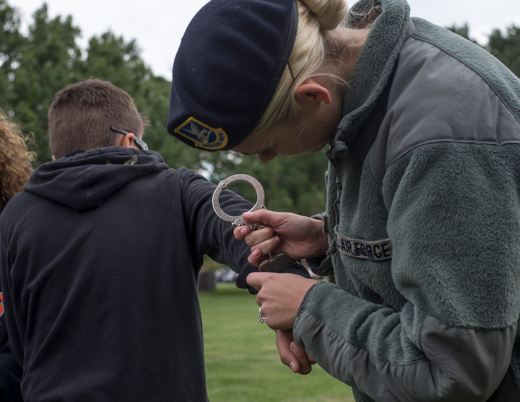 Senior Airman Amy Huelsmann, 375th Security Forces Squadron, demonstrates the use of handcuffs during Scott Air Force Base's Science, Technology, Engineering, and Math education event on Sept. 29, 2016.