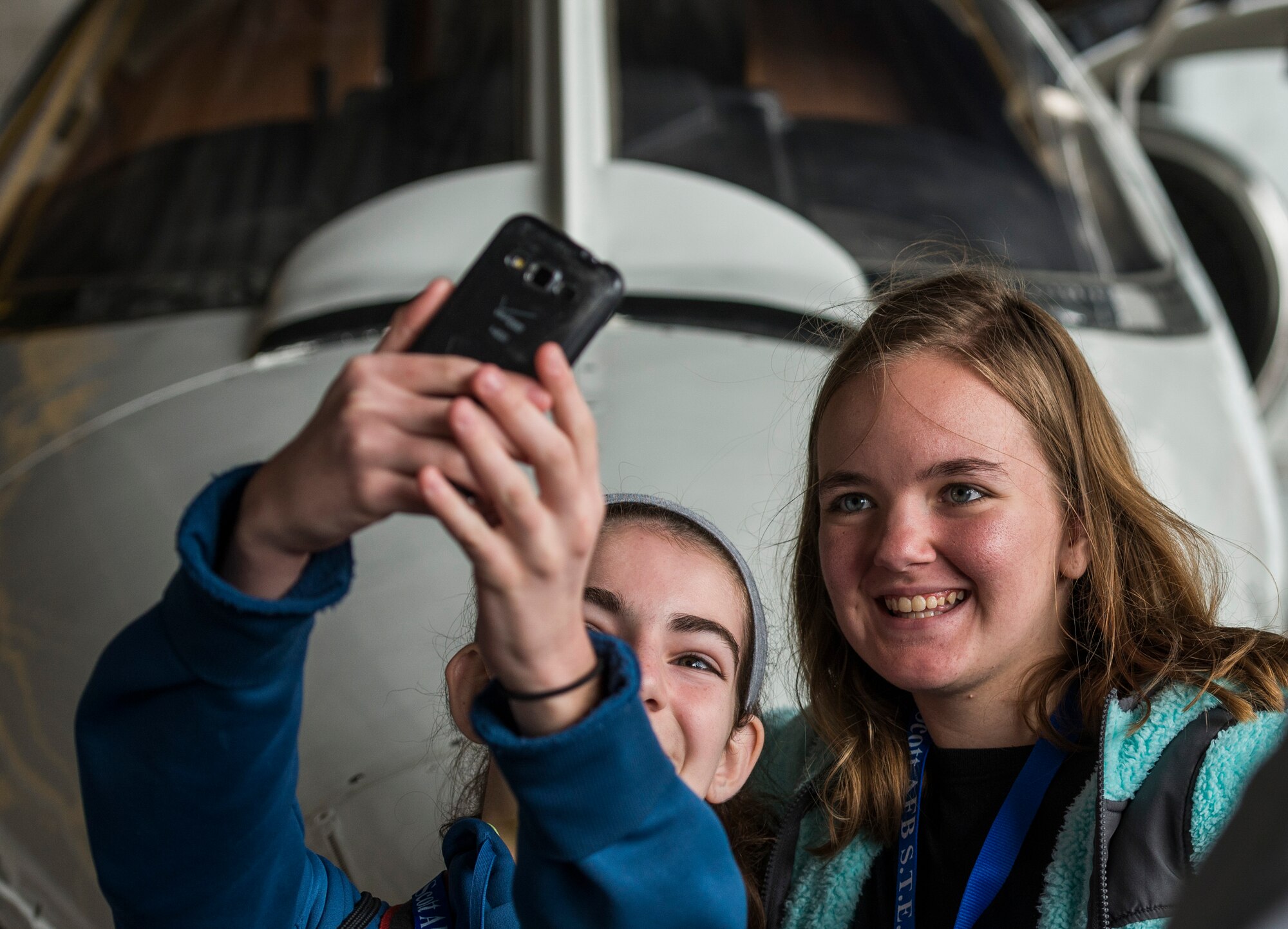 Two eighth graders take a selfie in front of the C-21A during Scott Air Force Base's Science, Technology, Engineering, and Math education event on Sept. 29, 2016.