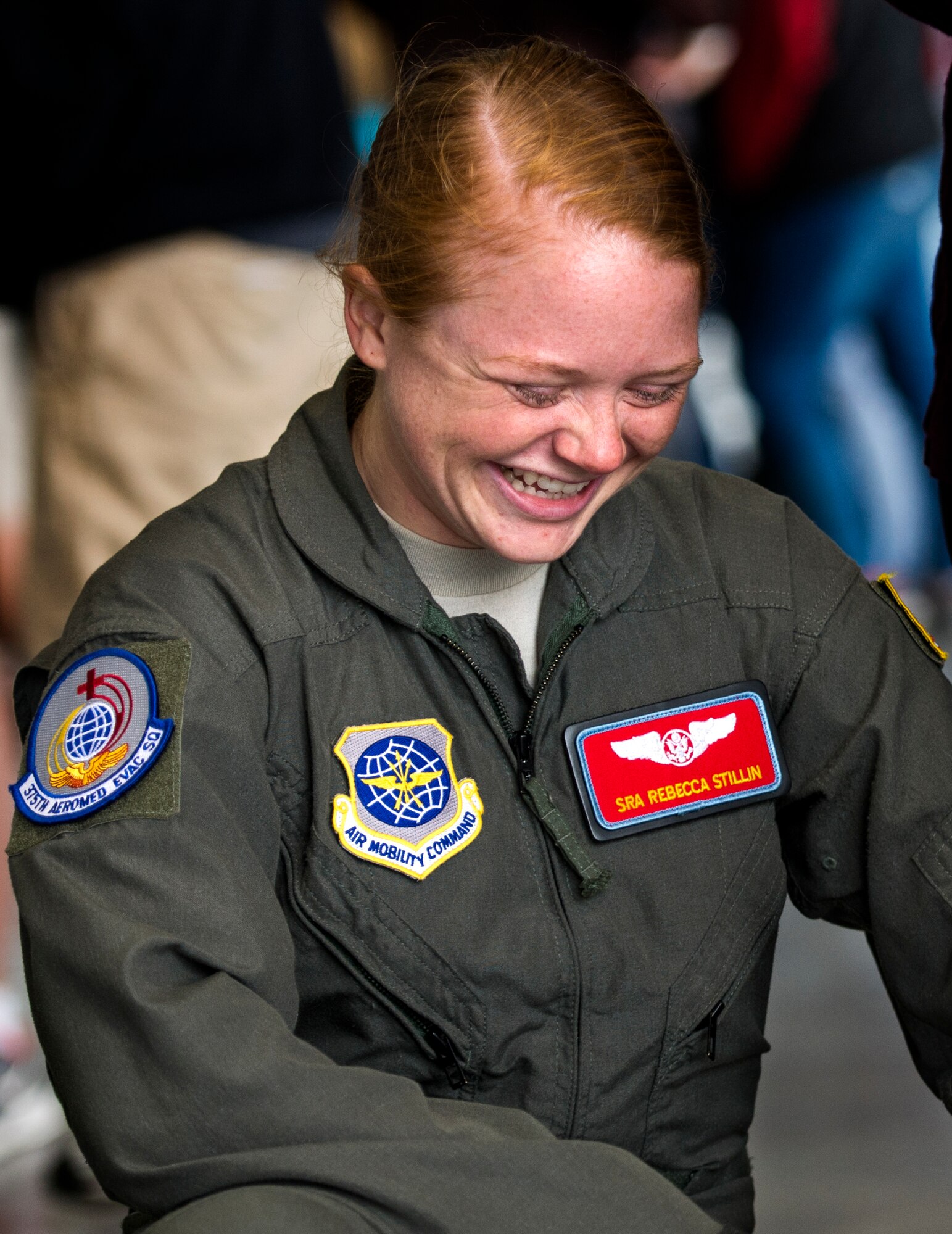 Senior Airman Rebecca Stillin, 375th Aeromedical Evacuation Squadron, laughs during a demonstration about the 375th AES, which was given to middle school students in the surrounding area, Scott Air Force Base, Ill., Sept. 29, 2016.