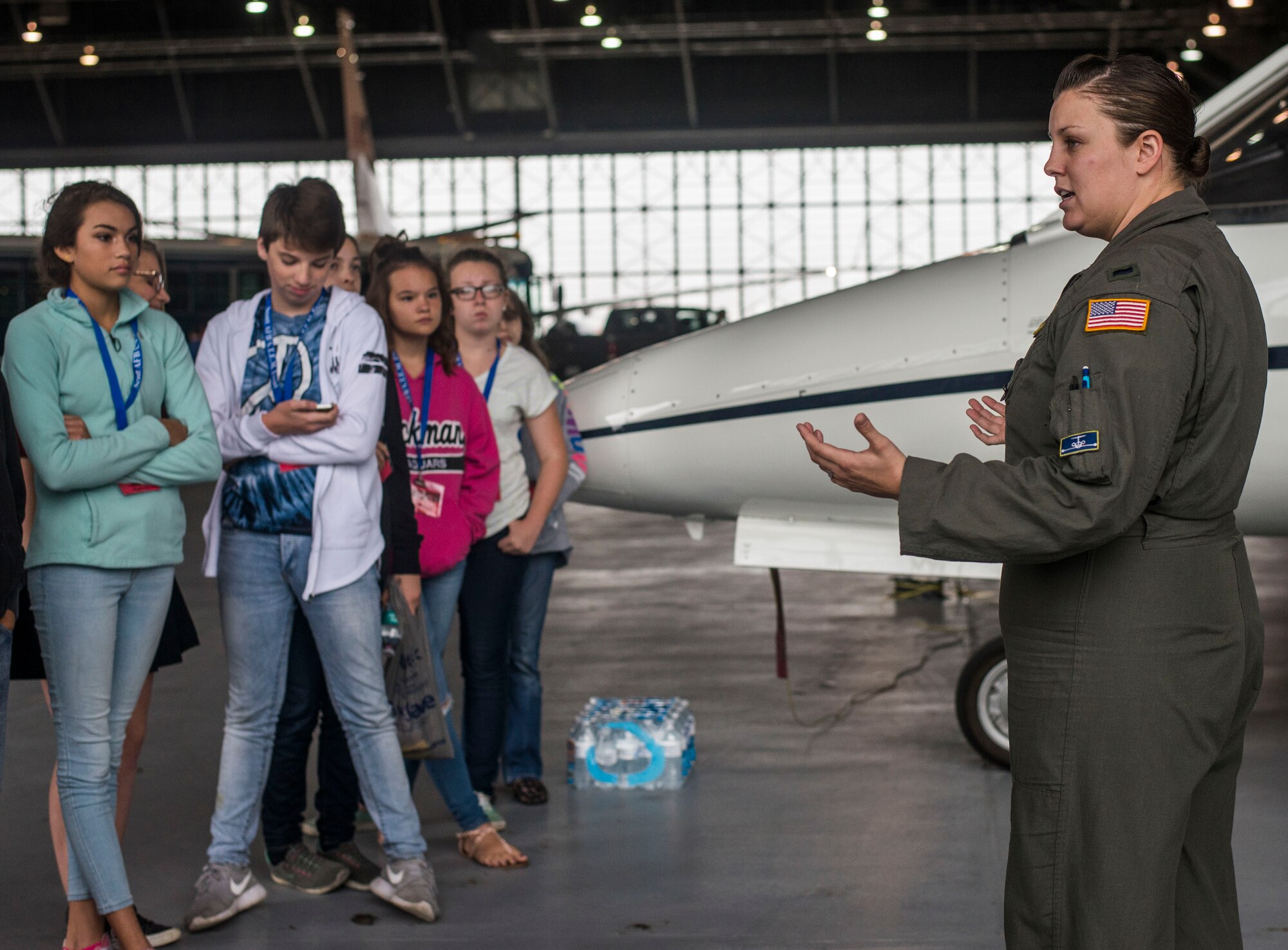1st Lt. Mackenzie Schofield, 458th Airlift Squadron, briefs middle school students on the C-21A, Scott Air Force Base, Sept. 29, 2016. Over 340 students from Central, Marissa, West, and Mascoutah Middle Schools attended Scott Air Force Base's Science, Technology, Engineering, and Math education event on Sept. 29, 2016.  The event was aimed at engaging and encouraging students to take an interest in STEM subjects at an early age and included demos on cyber hacking, live explosives, taser usage, aeromediac evacuation, radiology, patient transportation, medical equipment repair, and chemical, biological, radiological, nuclear, and explosive detection.  Additionally, the students learned about drones, developing mobile applications, virtual reality games, the C-21, field response, weather, explosive ordinance devices, cyber security, and video game hosting.  