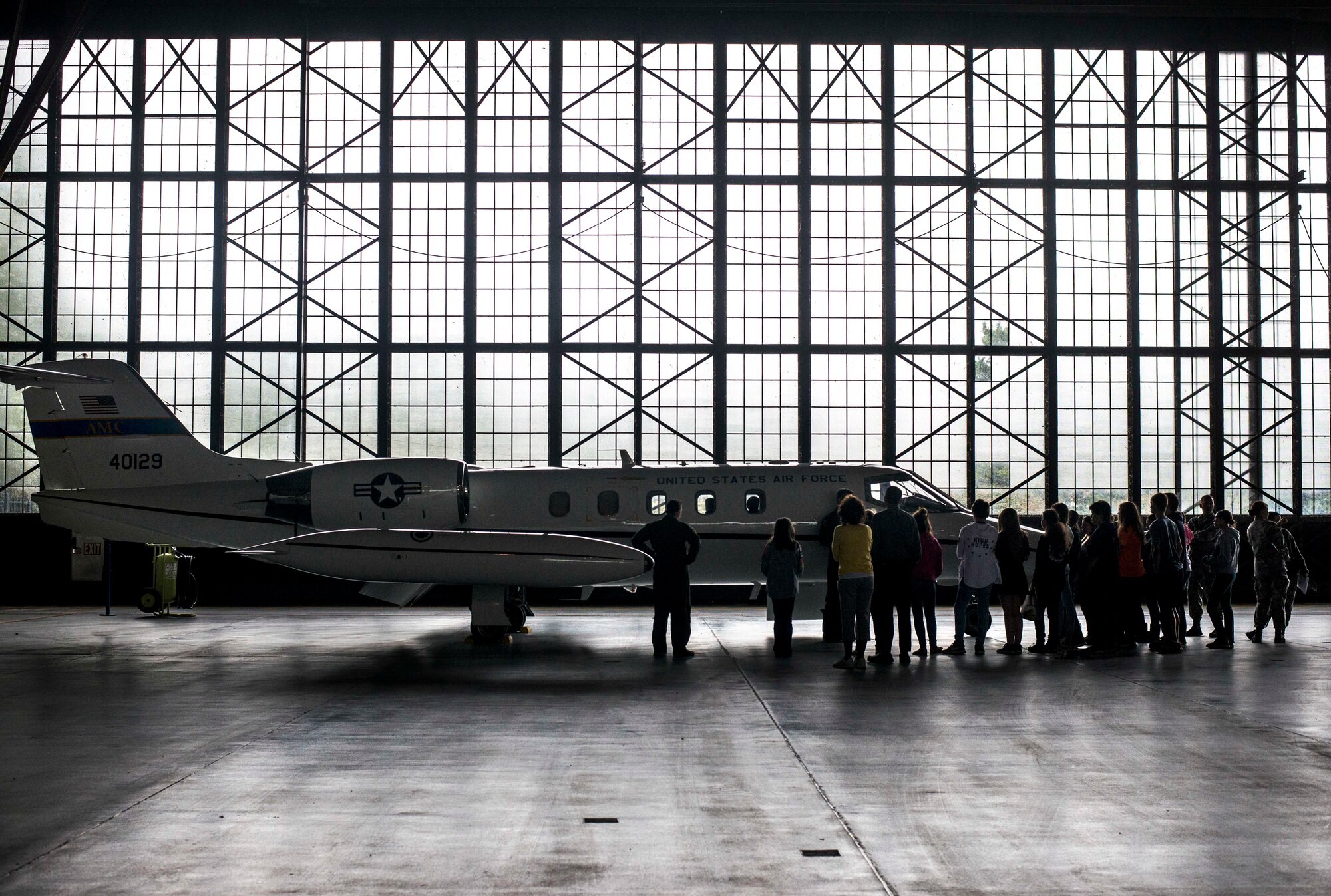 Middle school students listen to a brief on the C-21 A at Scott Air Force Base, Sept. 29, 2016. Over 340 students from Central, Marissa, West, and Mascoutah Middle Schools attended Scott Air Force Base's Science, Technology, Engineering, and Math education event on Sept. 29, 2016.  The event was aimed at engaging and encouraging students to take an interest in STEM subjects at an early age and included demos on cyber hacking, live explosives, taser usage, aeromediac evacuation, radiology, patient transportation, medical equipment repair, and chemical, biological, radiological, nuclear, and explosive detection.  Additionally, the students learned about drones, developing mobile applications, virtual reality games, the C-21, field response, weather, explosive ordinance devices, cyber security, and video game hosting.  