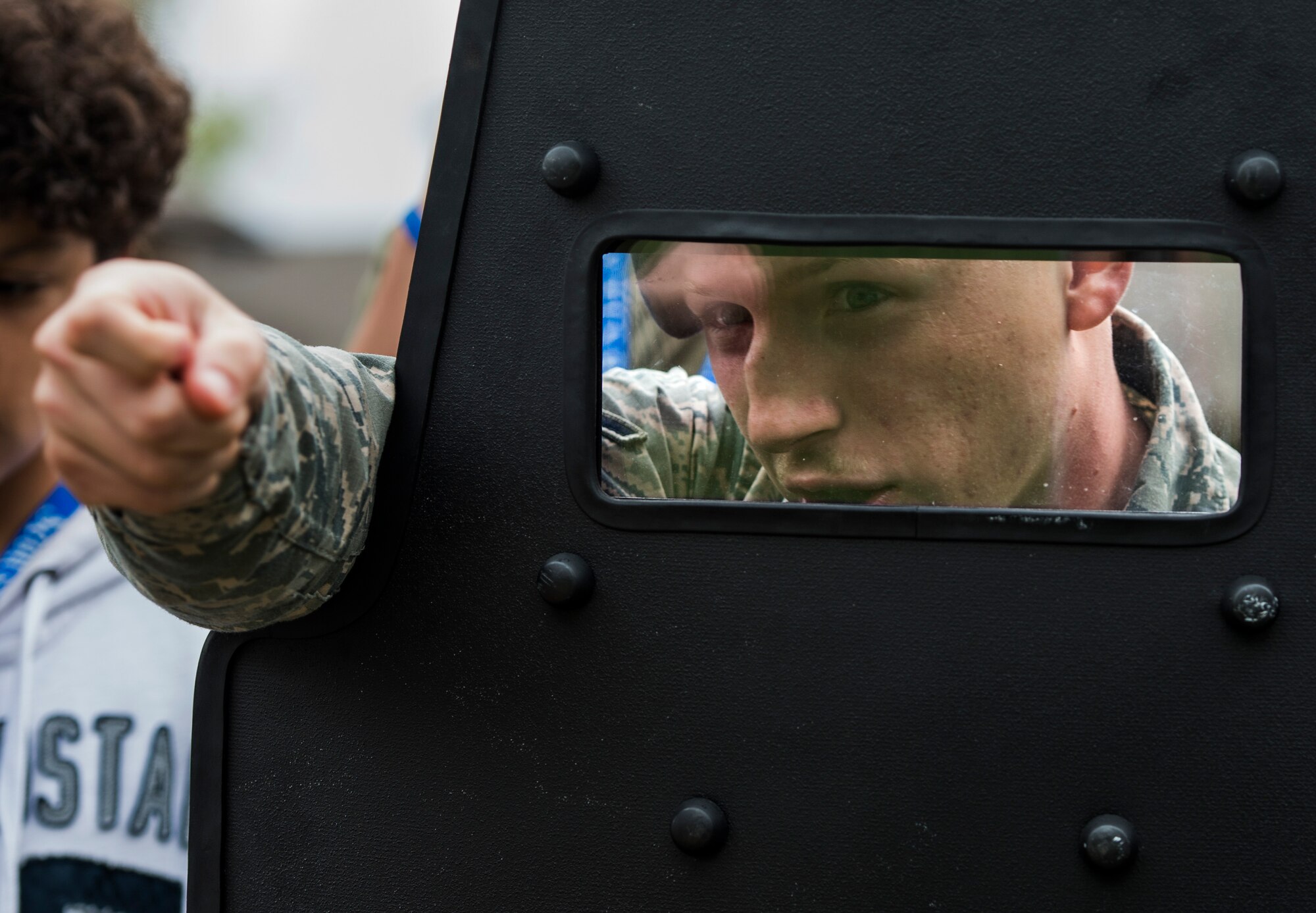 Airman Dylan Crosby, 375th Security Forces Squadron, demonstrates how his unit uses a riot shield in conjunction with a weapon.  