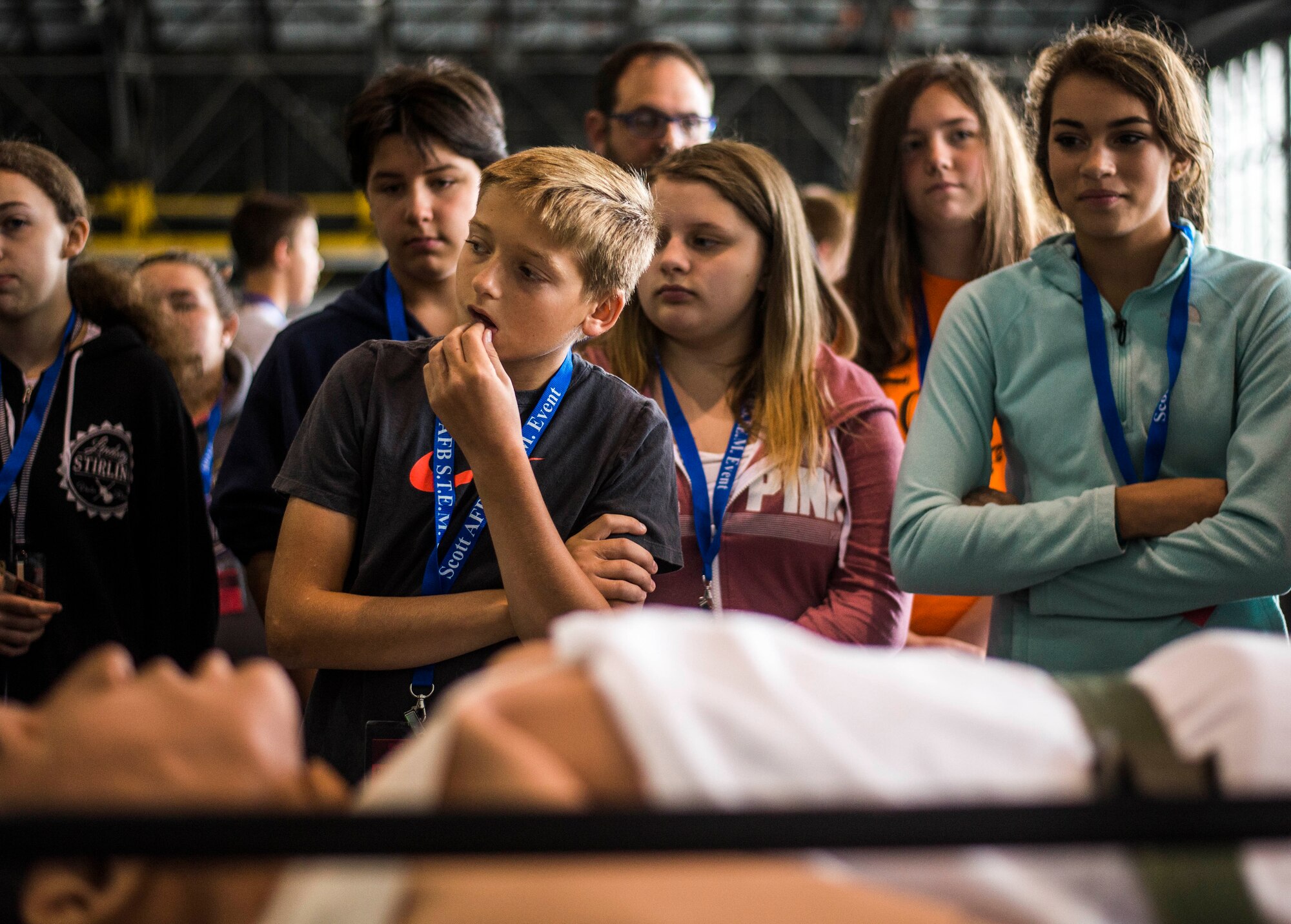 Middle school students listen to Aeromedical Evacuation Squadron demonstrations on proper procedures for handling patients.  