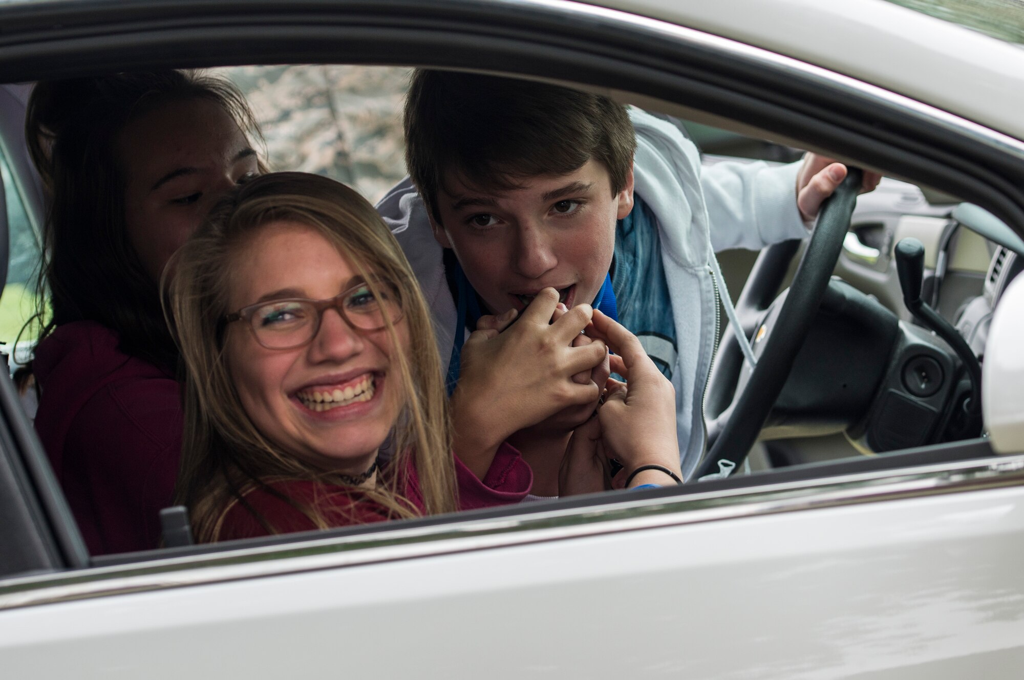 Middle school students from the surrounding area use the intercom of a 375th Security Forces Member patrol car.